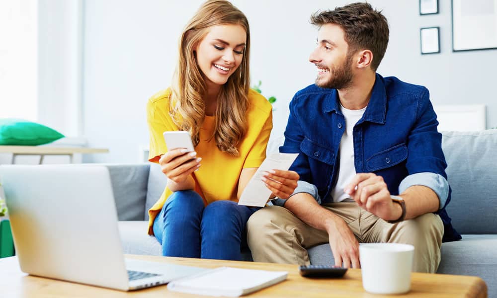 Couple Looking at Receipts on Couch